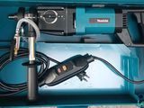 a blue box with a drill and a cord in it