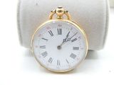 a small gold pocket watch with roman numerals on it