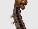 a close up of a musical instrument with a lion head on top of it