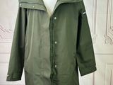 an image of a green rain coat on a mannequin mannequin
