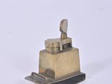 a small metal object that is sitting on a white surface