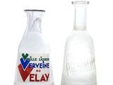 two glass vases that are next to each other on a table