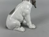 porcelain figurine of a dog sitting on its hind legs