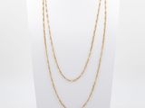a gold chain necklace on a mannequin mannequin