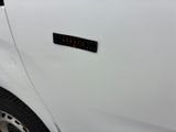 a close up of a white truck with a sticker on it