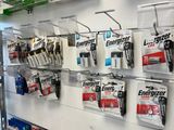 many different types of batteries hanging on the wall