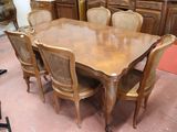 a large wooden table and chairs in a room