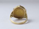 an image of a gold ring with a stone in the middle