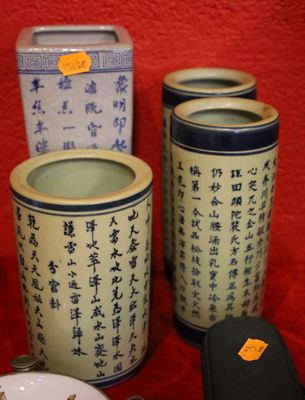 three containers with asian writing on them on a red cloth