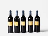 three bottles of wine are lined up against a white background