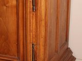 a wooden cabinet with a marble top in a room