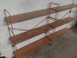 a wooden shelf with three shelves on each side of it