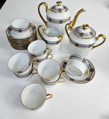 many cups and saucers sitting on a white table