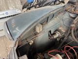 an old car that is sitting in the dirt