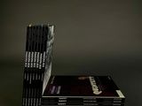 books stacked on top of each other on a black surface