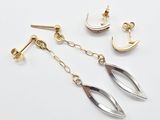 une paire de boucles d'oreilles en or et en argent sur fond blanc