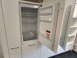 an image of a white refrigerator in a room