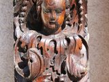 carved wood carving of a man and a woman on a wall