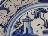 a blue and white plate with a picture of a castle on it