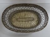 a metal basket with a handle hanging on the wall