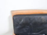 a black leather chair with a black seat and a brown back
