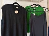 two shirts hanging on a rack in a clothing store