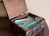 a wooden box with a cloth inside on a table