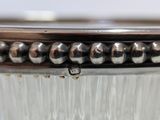 a close up of a glass container with beads on it