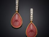 a pair of coral and diamond earrings