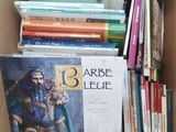 a cardboard box filled with books and a bunch of other books