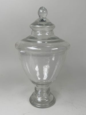 a clear glass jar with a lid on a table