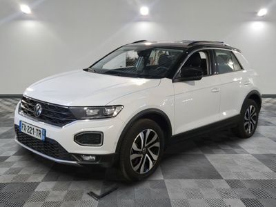 a white volkswagen t - cross parked on a checkered floor