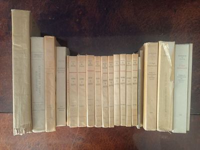 several old books are stacked on top of each other on a table