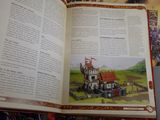an open book with a picture of a castle on it
