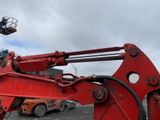 a large red machine that is sitting in a parking lot