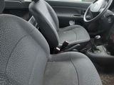 the interior of a small car with a steering wheel and a dashboard
