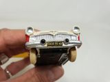 a person holding a cell phone with a toy car on it