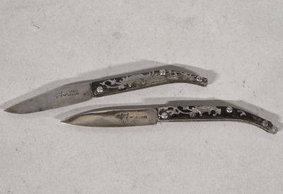 two knives that are sitting on a table