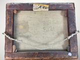 an old picture frame with a piece of fabric hanging from it ' s side
