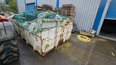 a large container with a net on top of it in front of a building