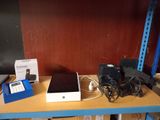 several electronic devices are sitting on a shelf in a room