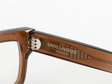 the frame of a pair of glasses is made of brown plastic