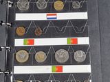 a lot of different coins in a binder on the table