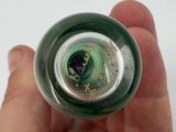a person holding a bottle with a green liquid inside of it