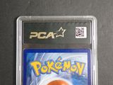 a pokemon card in a plastic case on a table