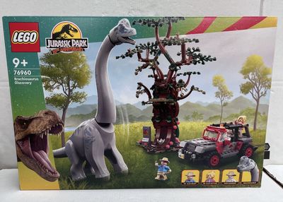 a box with a toy dinosaur and a toy car in it