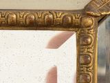 a picture of a mirror with a gold frame on it