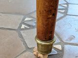 an image of a close up of a wooden pole on a tiled floor
