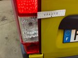 a sticker on the back of a yellow car