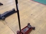 a red jack sitting on the floor in a gym